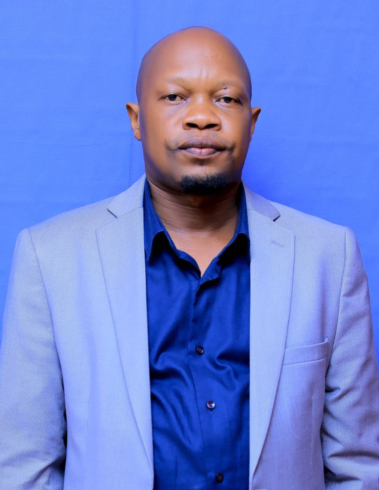 Daras Director in a blue suit